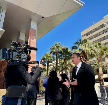 K. Ryan Helmick speaking with a television news crew outside the courthouse