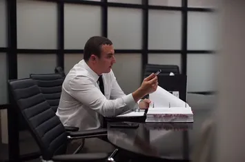 K. Ryan Helmick reviewing case files in the conference room