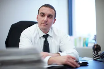K. Ryan Helmick at his desk at The Defense Firm