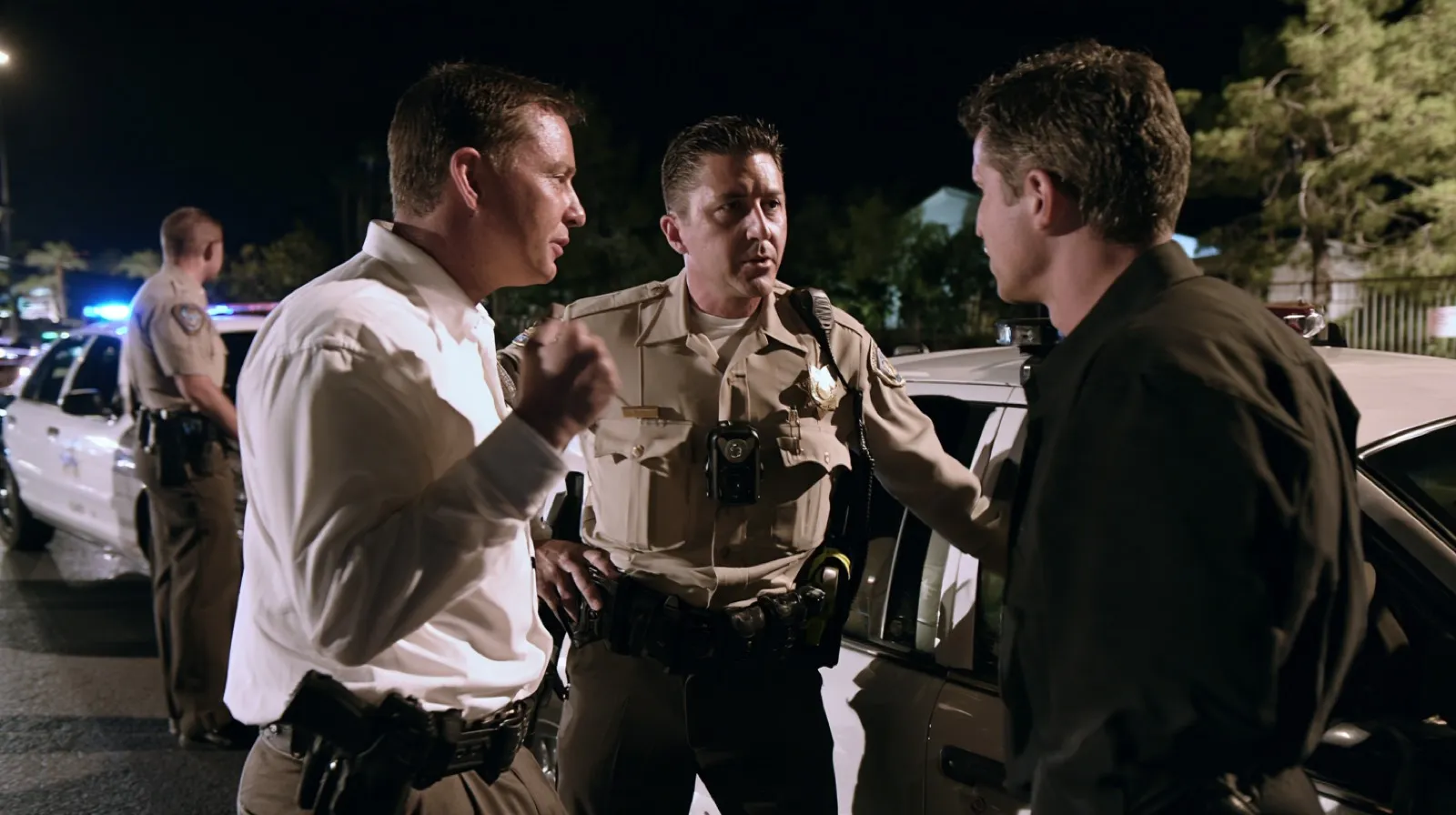 Las Vegas law enforcement officers wearing body cameras during a nighttime police encounter.
