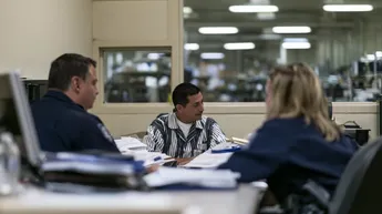 Nevada correctional staff reviewing documents with an incarcerated person to determine classification and prison placement.
