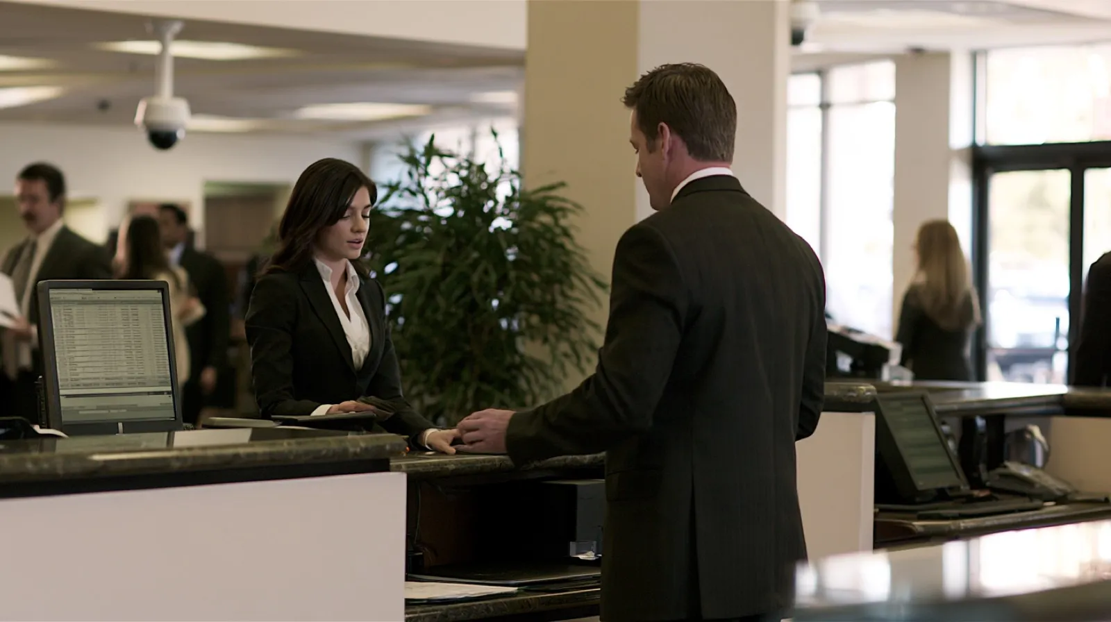 Bank employee processing a customer transaction, representing financial records used to trace money in a Nevada laundering case.
