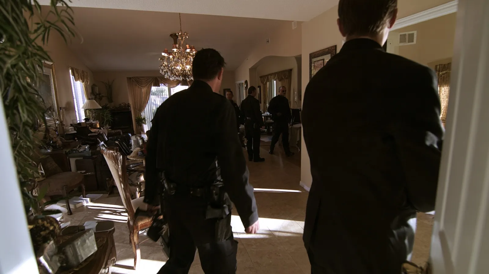 Law enforcement officers executing a search warrant inside a Nevada residence during a criminal investigation.