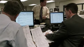 Investigators reviewing financial records, benefit claims, and digital data during a Nevada unemployment or insurance fraud investigation.