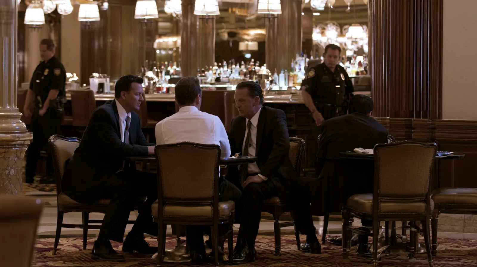 Investigators conducting surveillance inside a Las Vegas venue during a criminal investigation involving alleged vice offenses.
