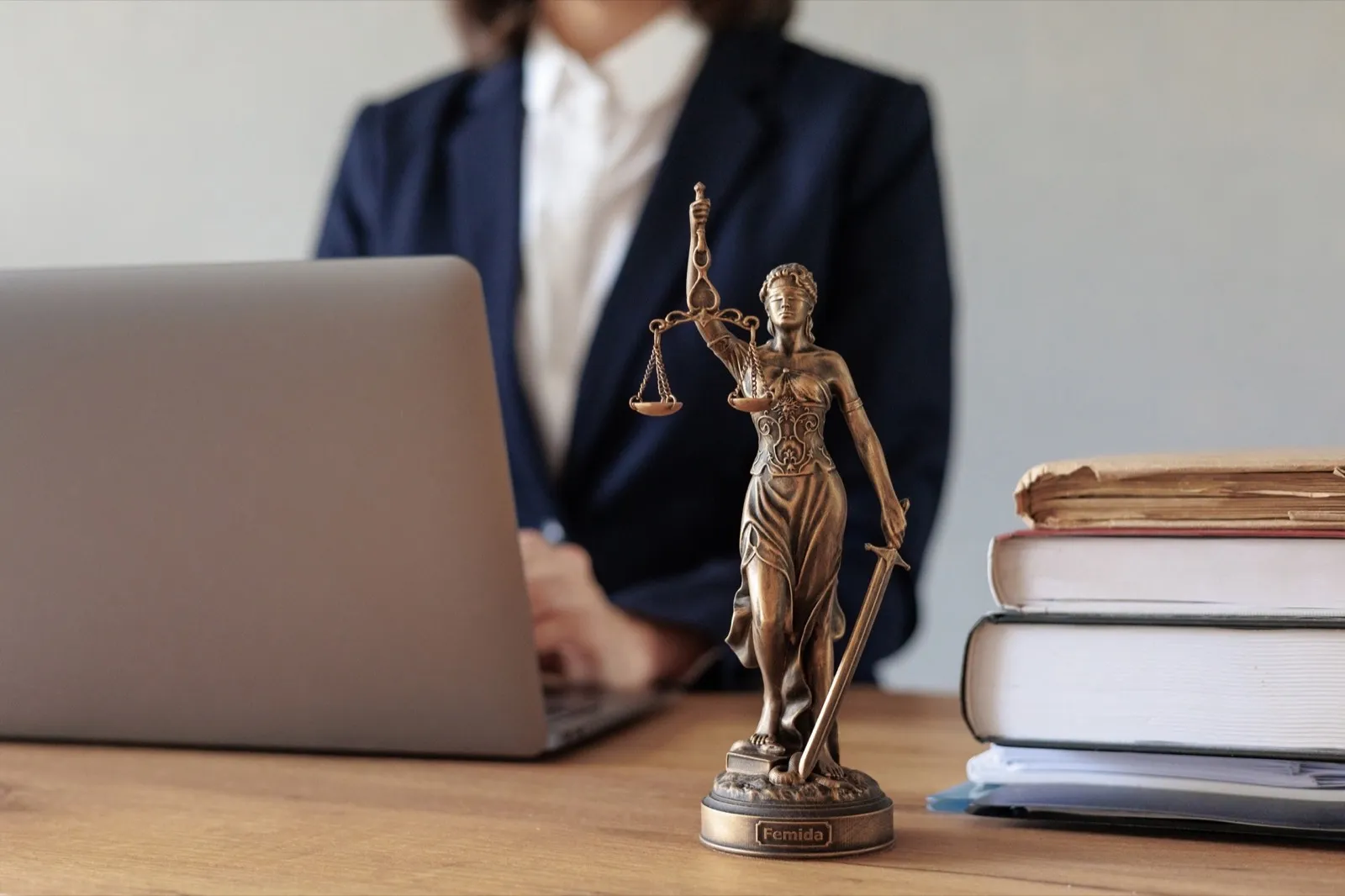 a European woman lawyer talk to clients on a webcam from a laptop. work in a law firm