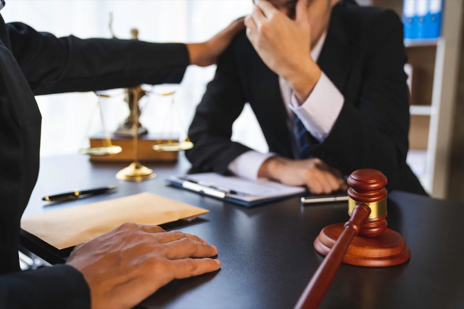 A lawyer or judge is encouraging. In a client’s courtroom at a lawyer’s office, litigation consultat