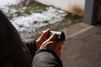 A man reloads a gun. out of the door, shooting range. Murder, danger, firearms