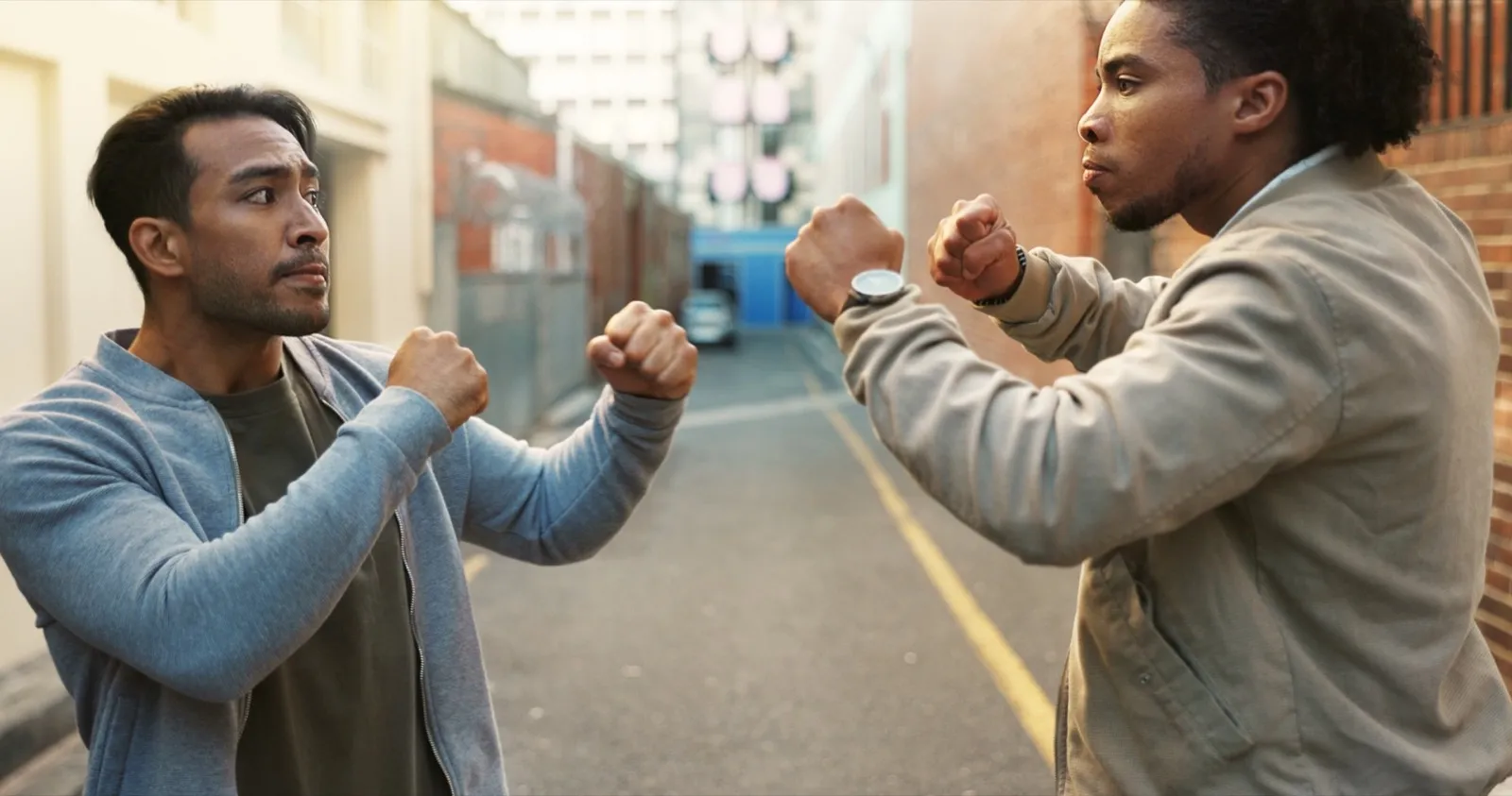 Angry men, city and fight for conflict, violence and disagreement or bullying in alley. Battle, fis