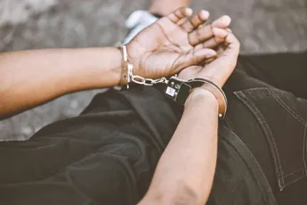 Arrest, justice and thief in handcuffs for fraud, violence and burglary after a suspected house rob