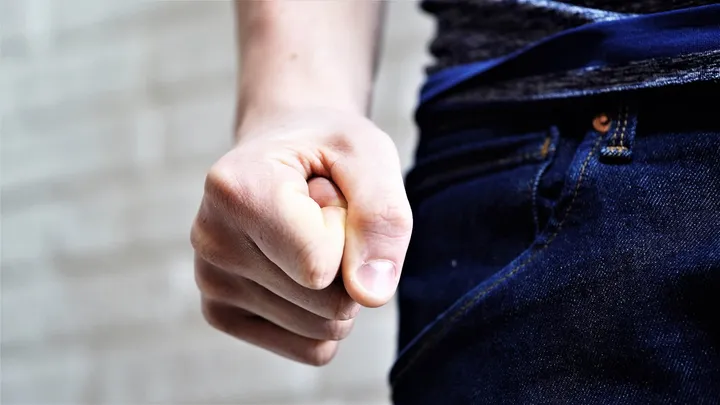 A man with a clenched fist is abusing the family