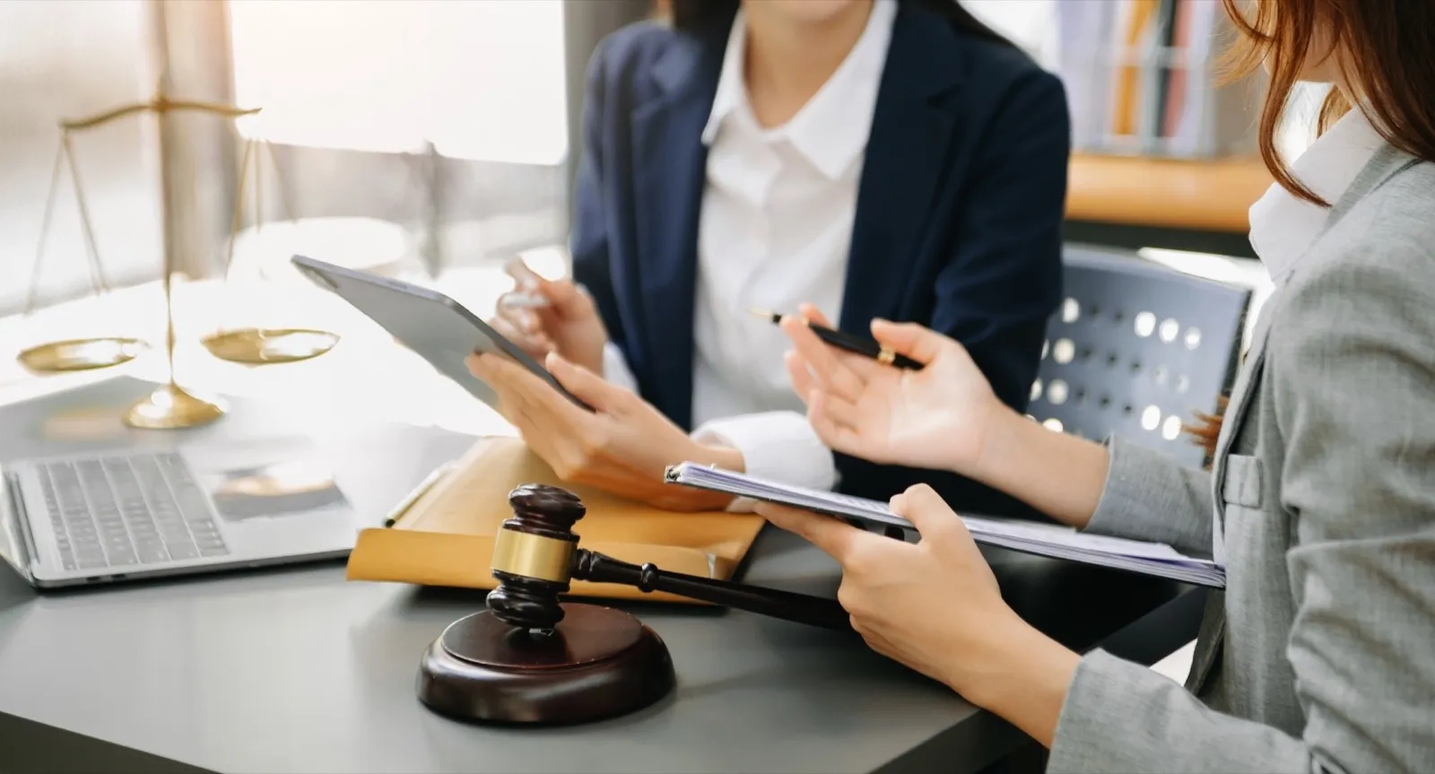 business people and lawyers discussing contract papers sitting at the table.