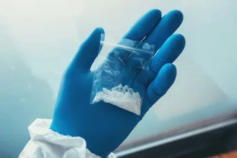 Criminology expert collecting drug evidence at crime scene