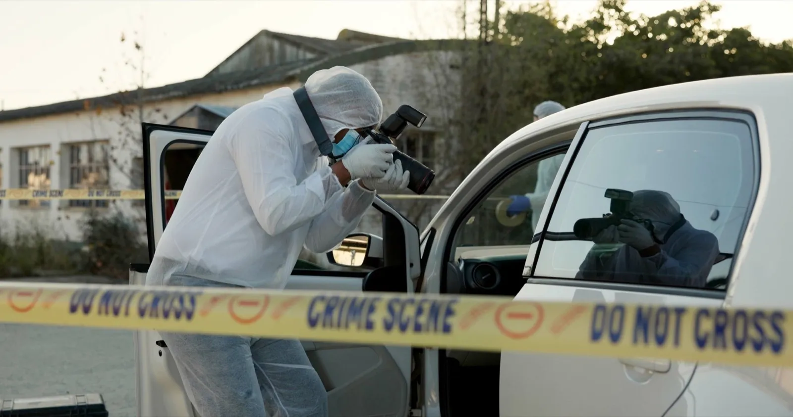 Detective, tape and crime scene of car evidence with photography, murder investigation and dna insp