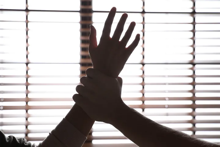 Man grabbing woman's hand