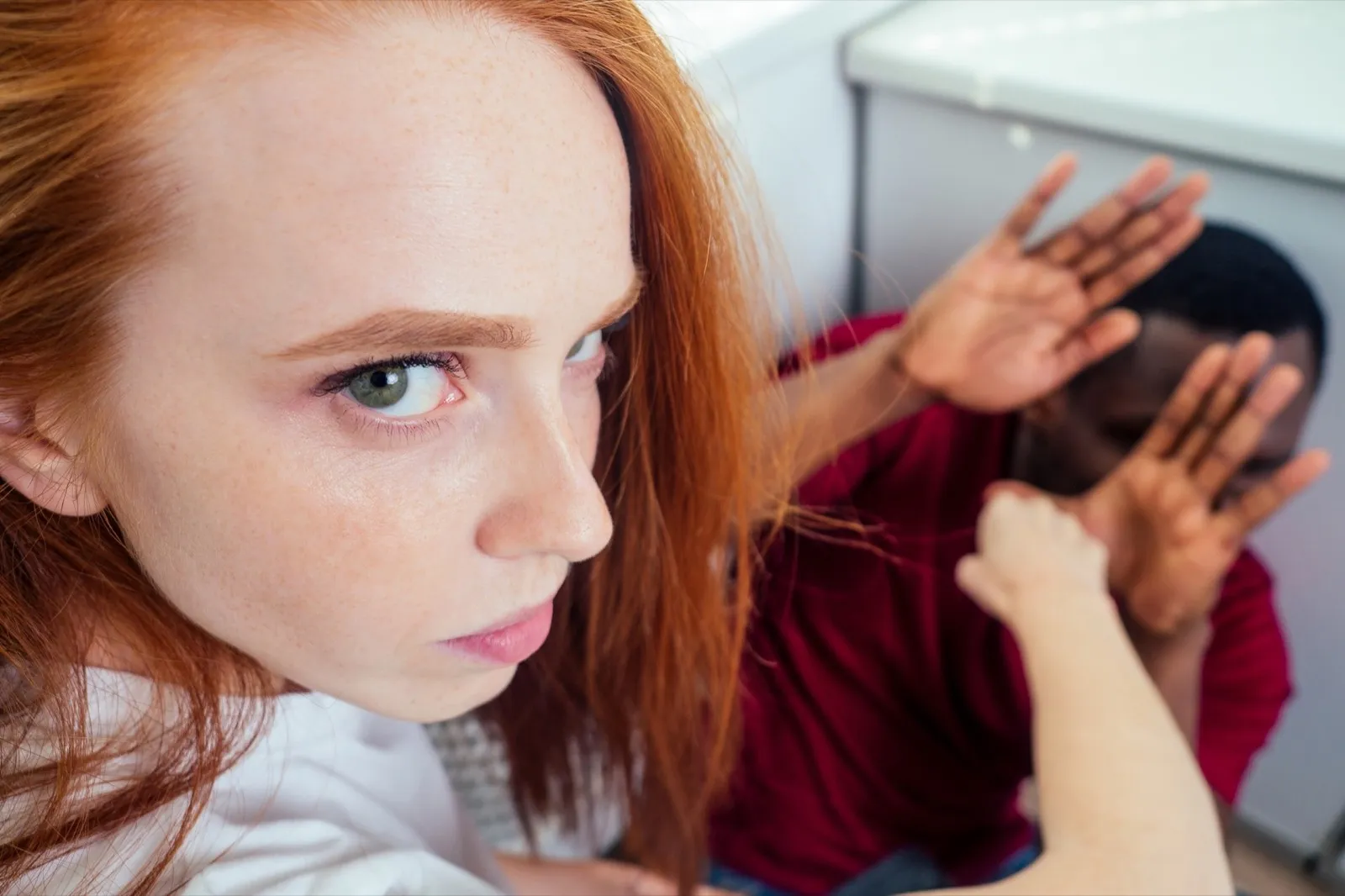 domestic violence. angry girl hitting african american man at kitchen