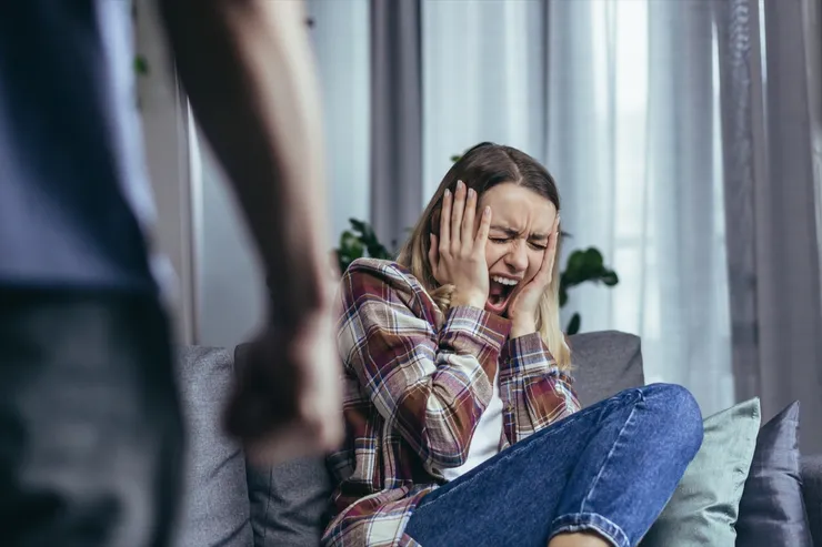 Domestic violence, angry husband shouting and beating woman, close-up photo