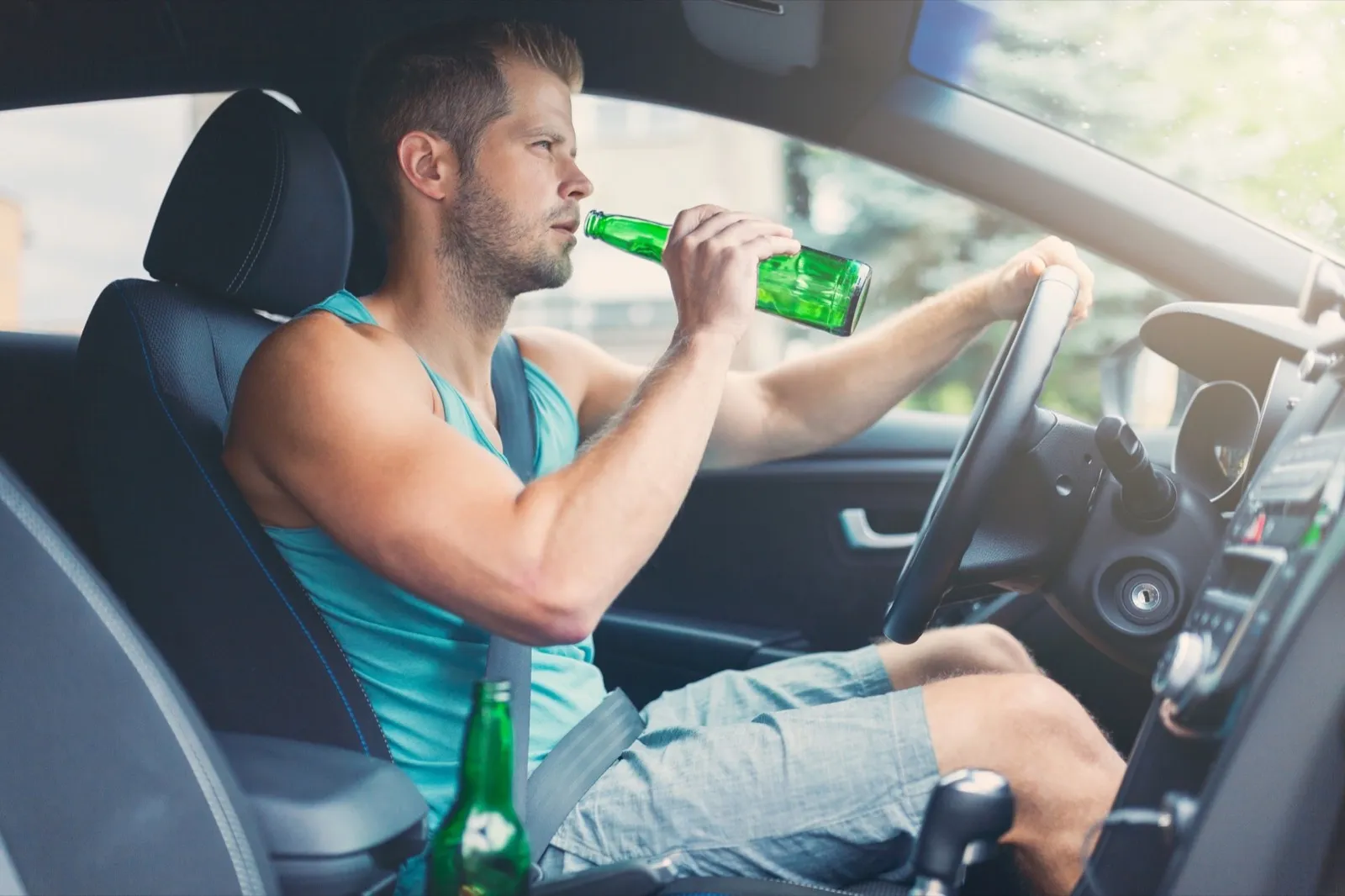 Drunk driver behind the steering wheel of a car