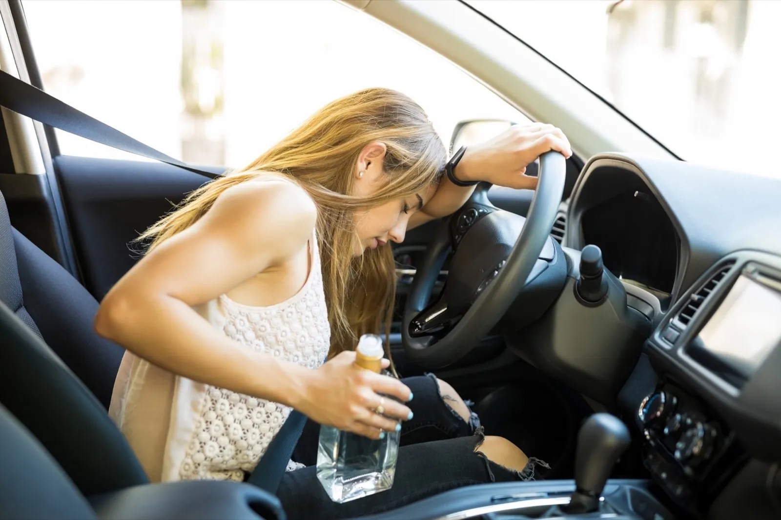 Drunk female driver sleeps in car