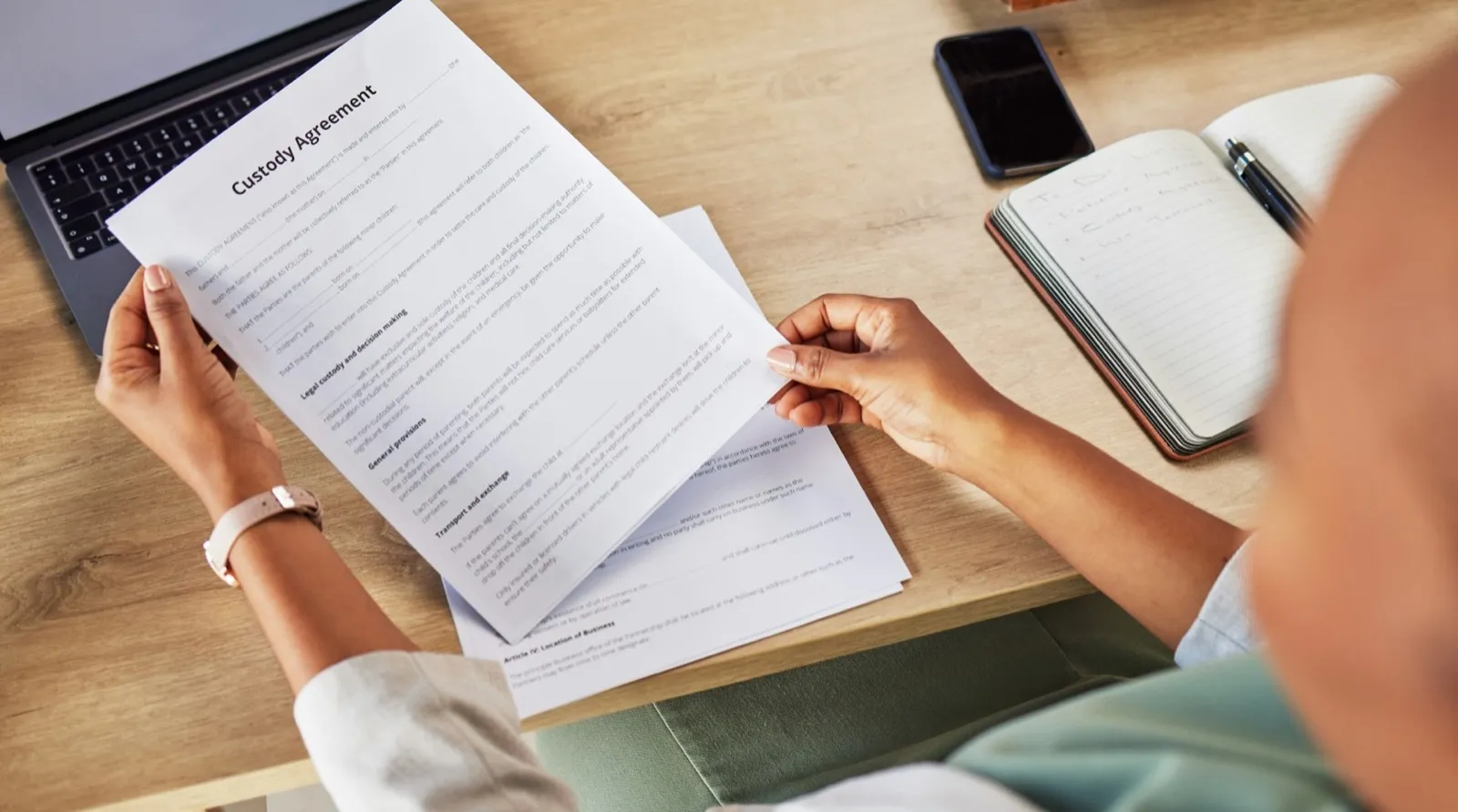 Family lawyer, hands and contract with attorney case and custody notes with agreement in a office.