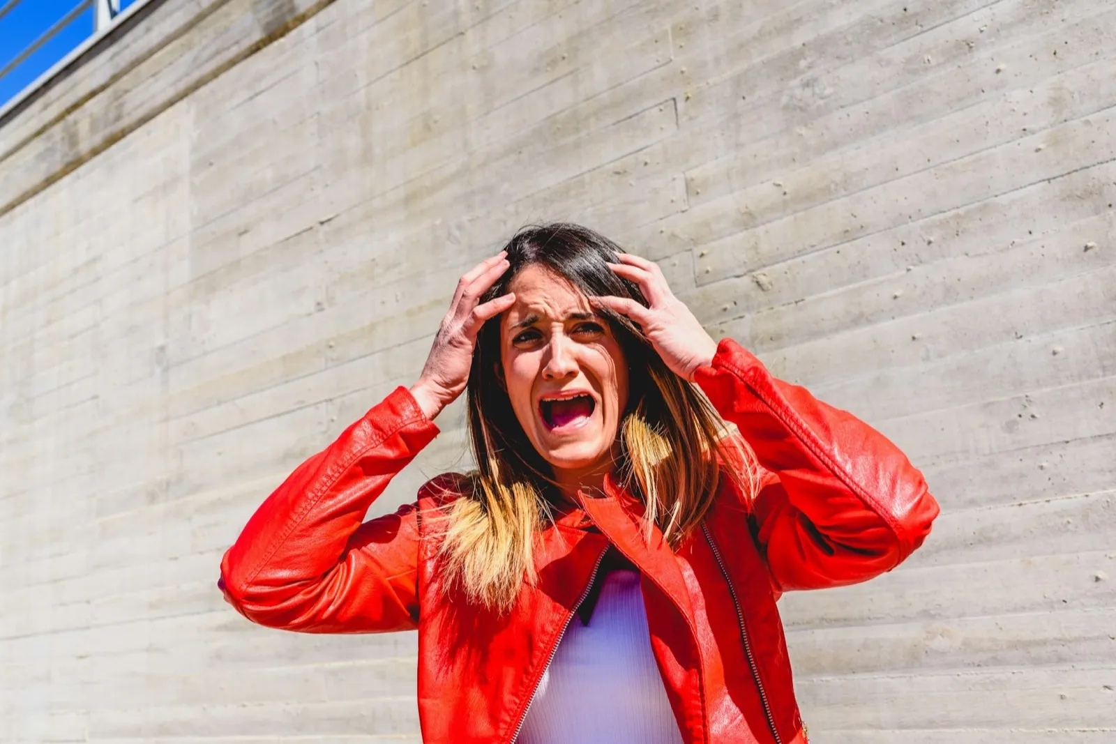 Frightened young woman gesturing with fear after a robbery.