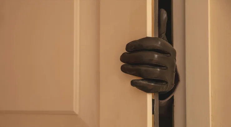 Gloved hand opening the door, Housebreaking, burglary concept