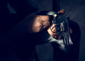 Hands holding the gun
