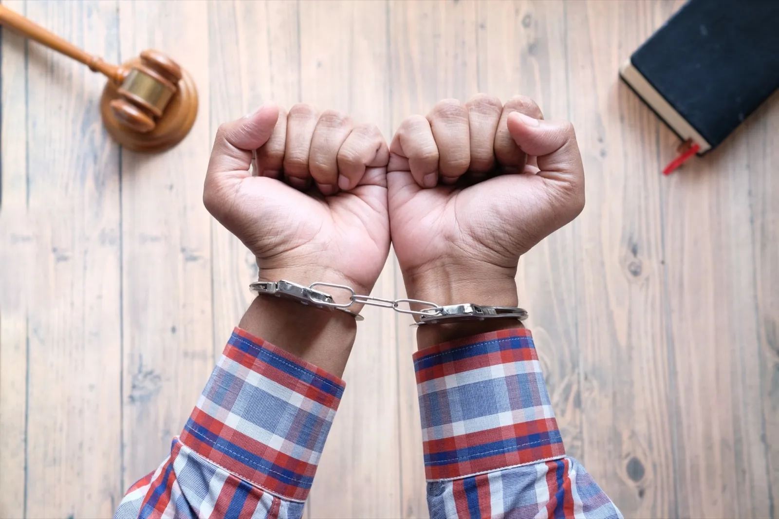 hands of a man with handcuffs close up.