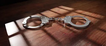Jail bar shadow and handcuff on a wooden table. Prison, conviction and incarceration. 3d render