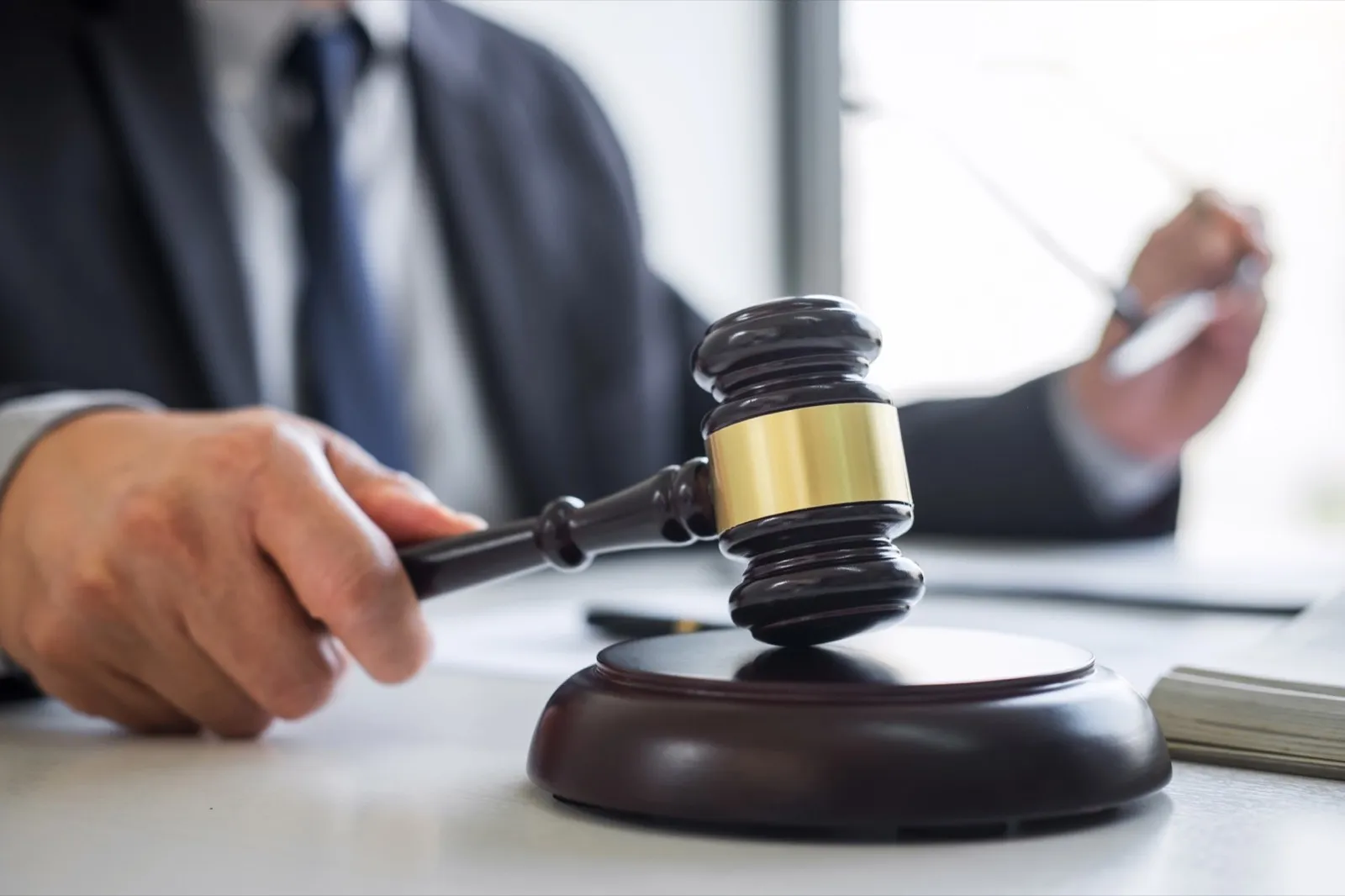 Judge gavel with Justice lawyers, Businessman in suit or lawyer working on a documents in courtroom