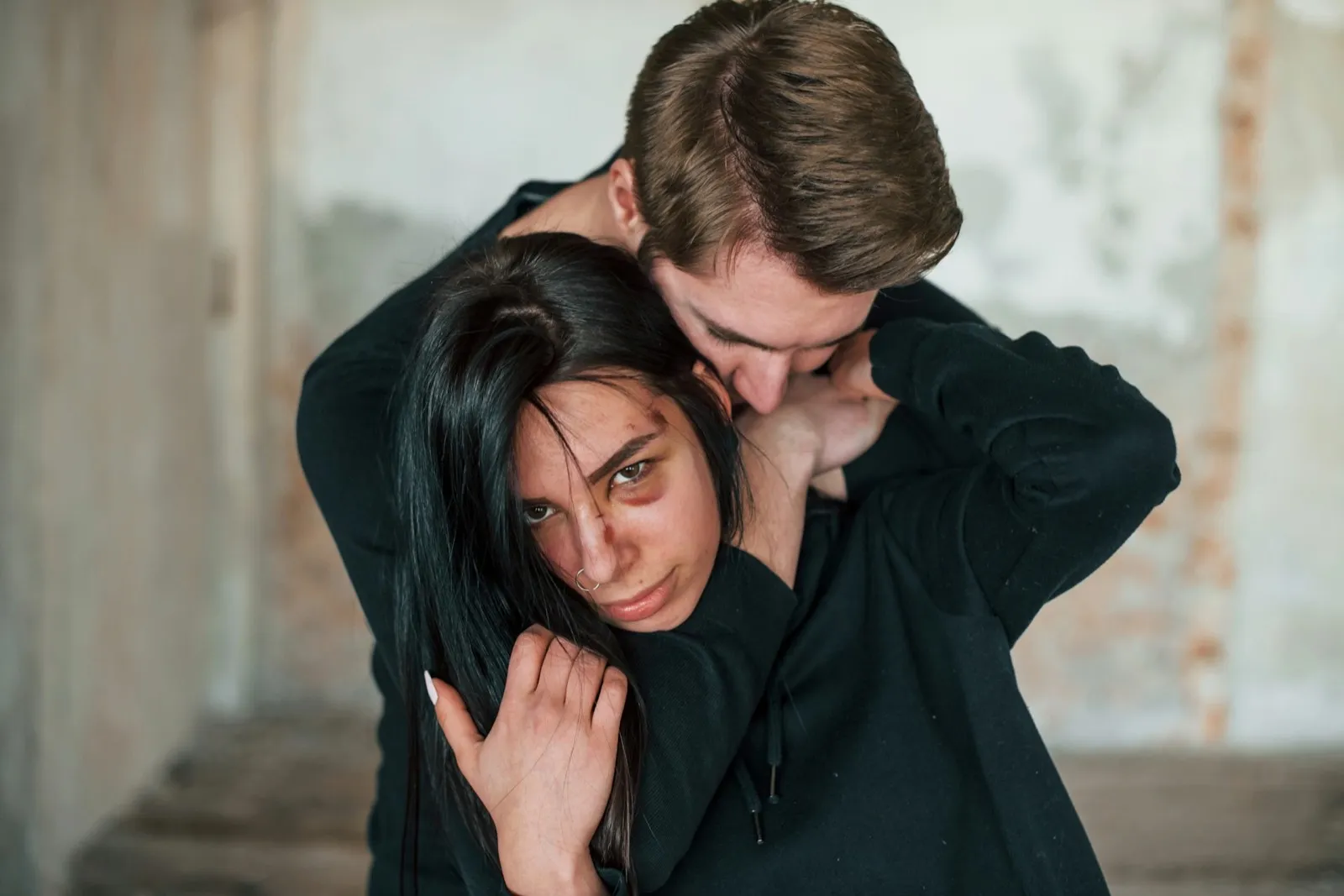 Kidnapped woman is threatened by man in abandoned building