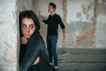 Kidnapped woman is threatened by man in abandoned building
