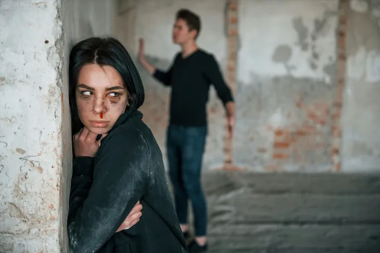 Kidnapped woman is threatened by man in abandoned building