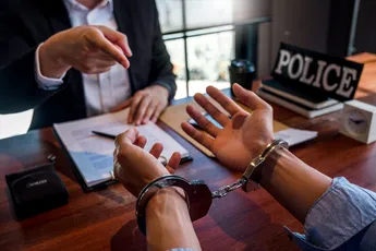 Law enforcement officer interrogating Criminals male