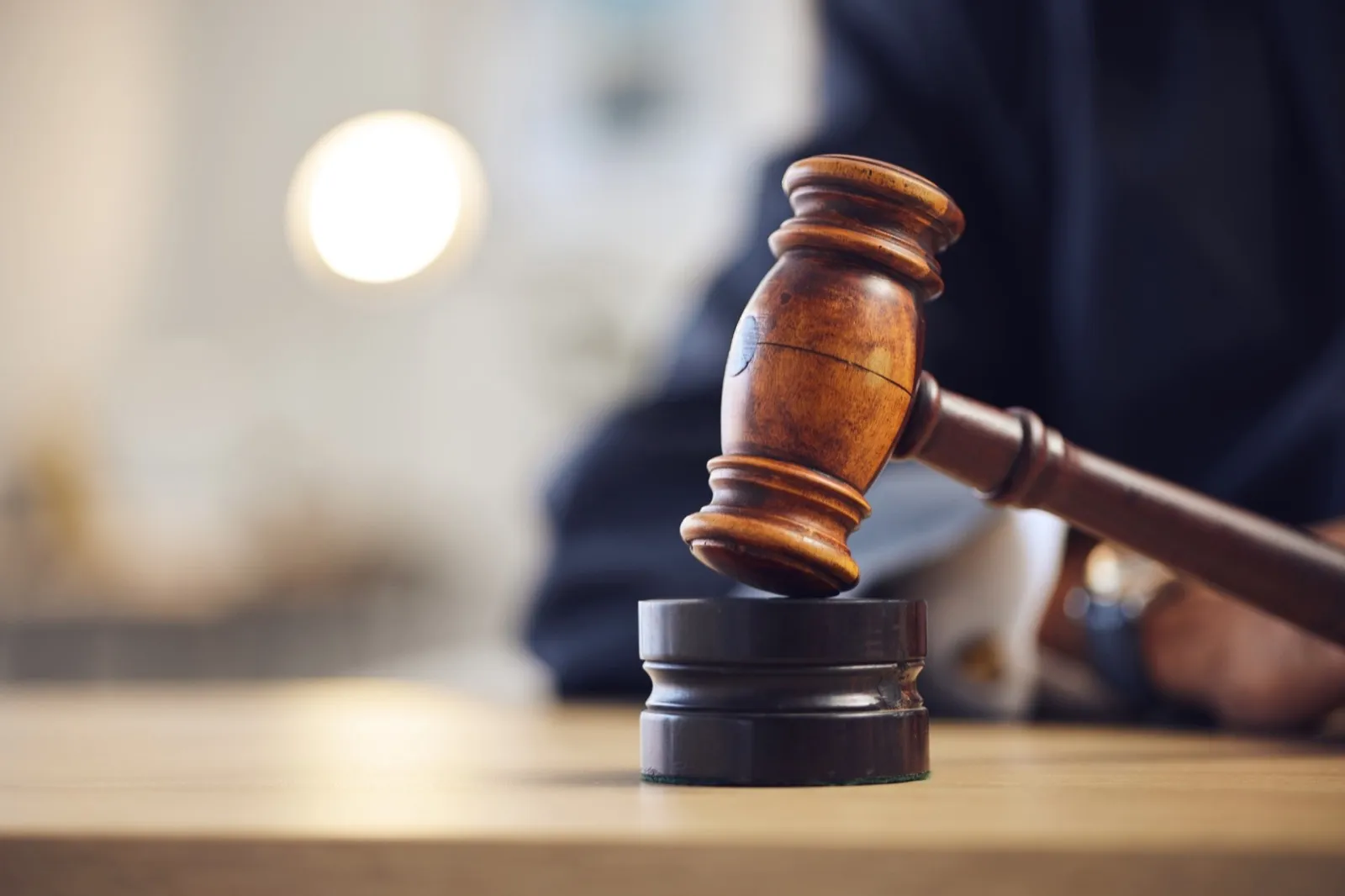 Law, judge and closeup of lawyer with gavel for justice, court hearing and legal trial for magistra