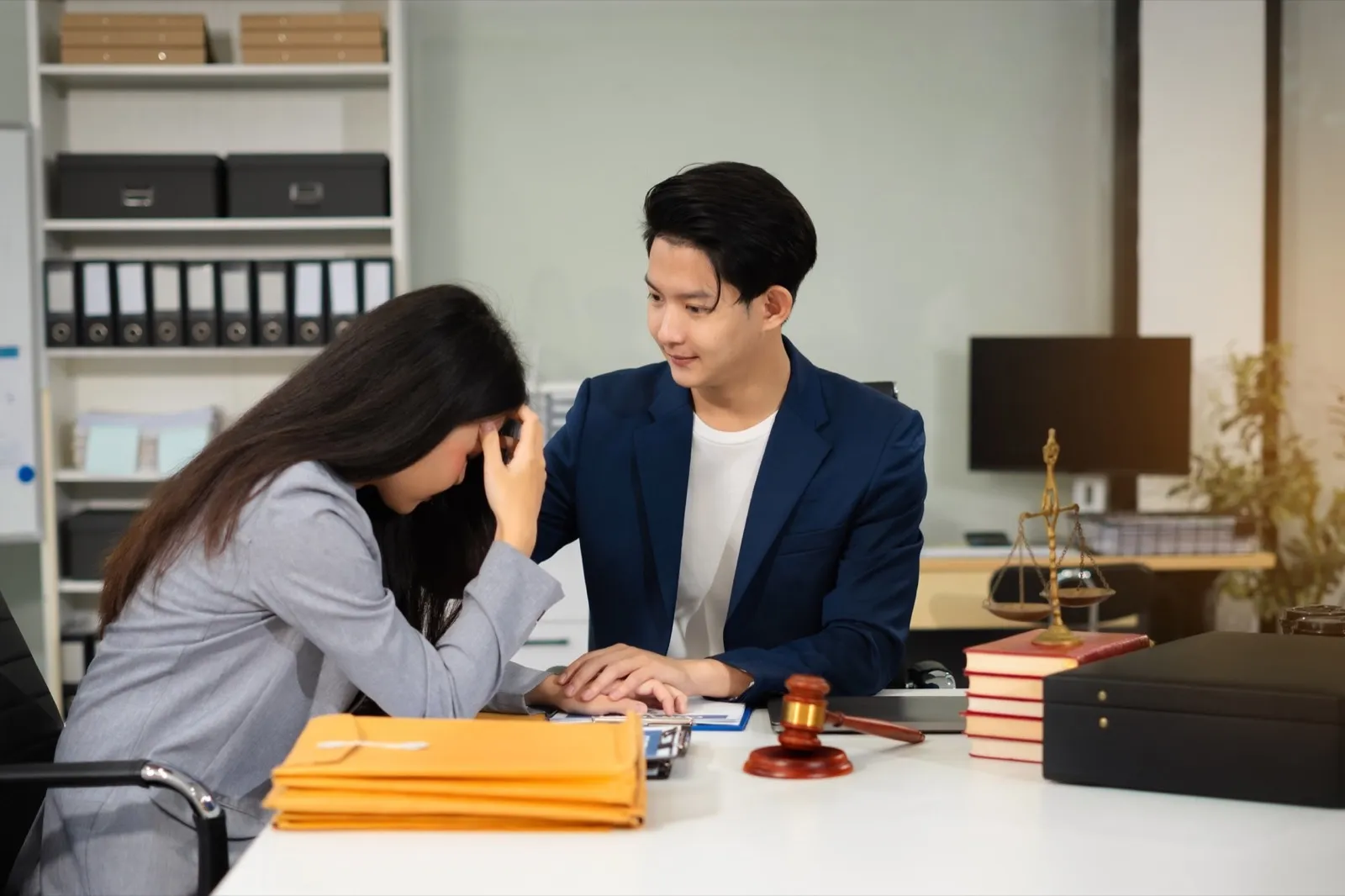 Lawyer comforts his clients with legal advice and serious stress trust commitment