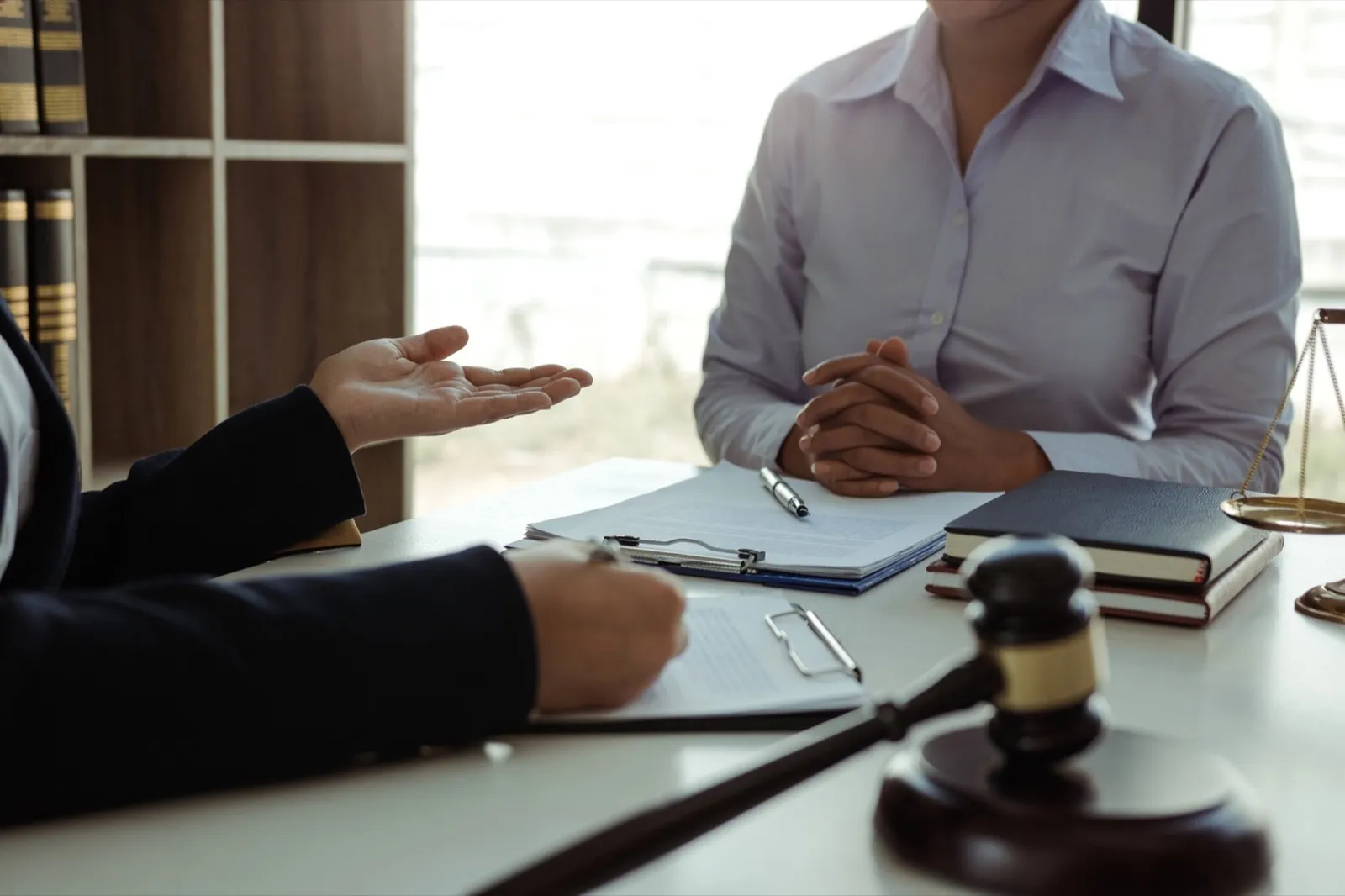 Lawyer is giving advice to clients who have consulted about legal issues regarding rights infringeme
