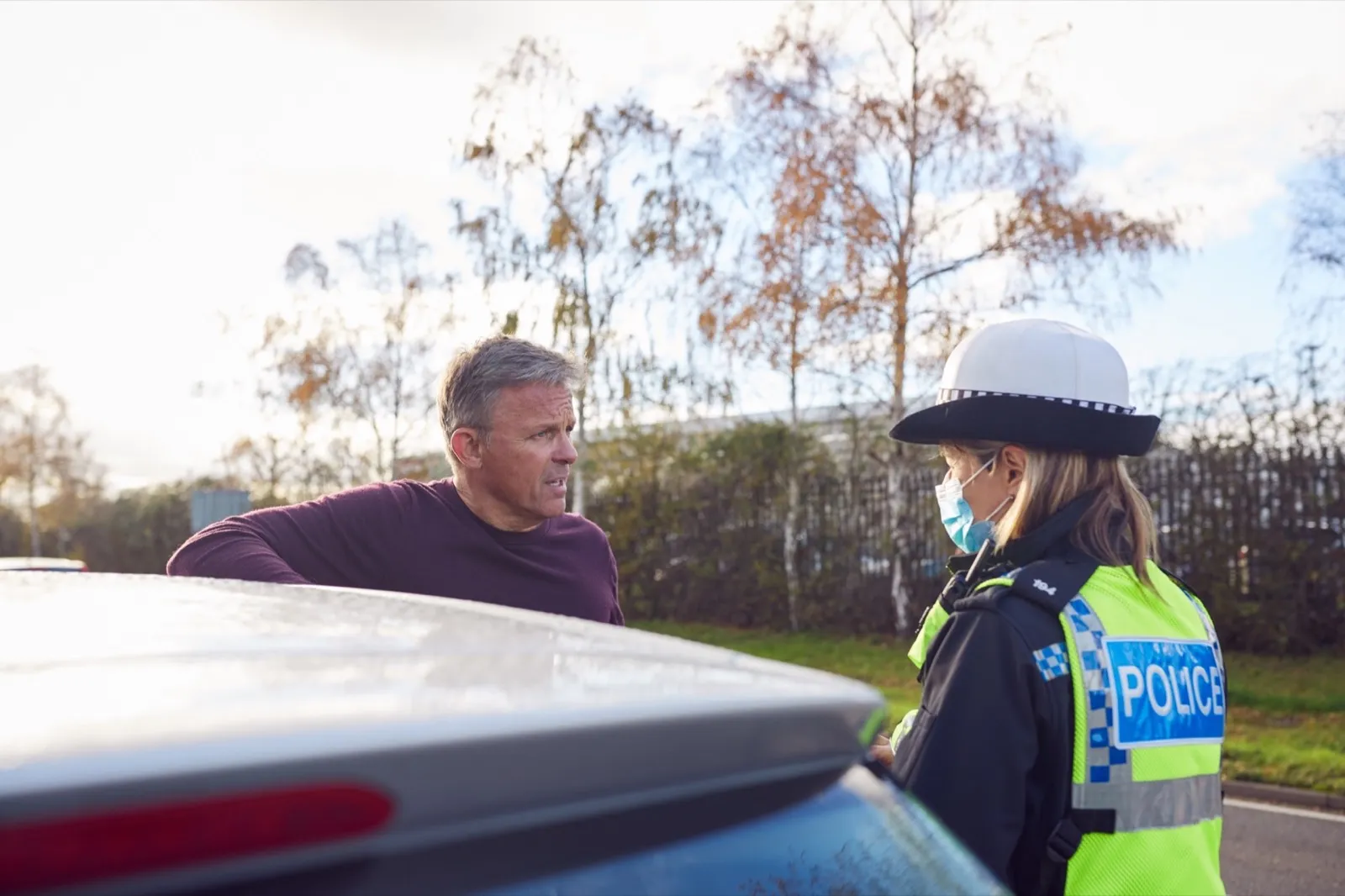 Male Driver Being Stopped By Female Traffic Police Officer For Driving Offence
