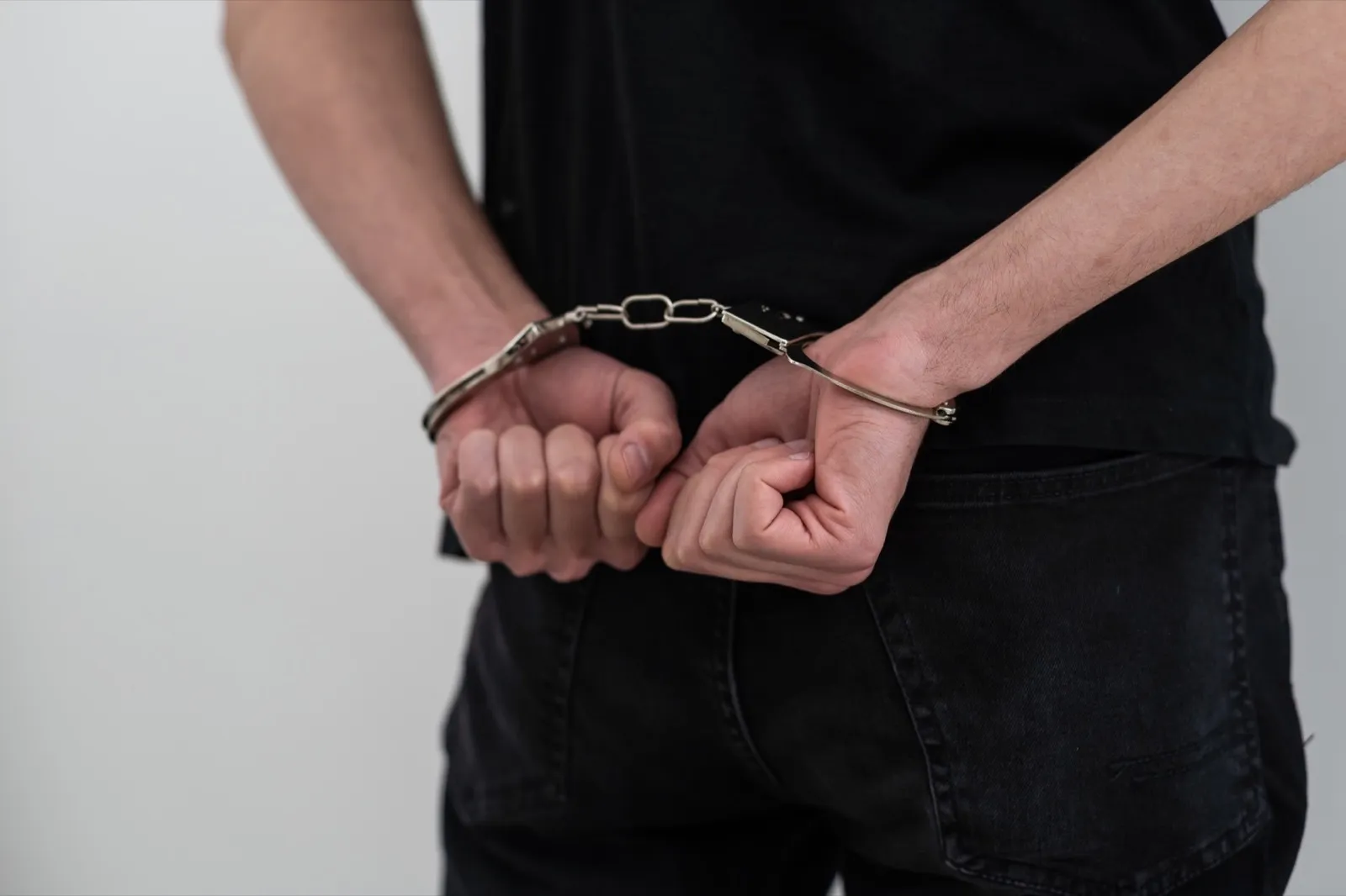 Man’s Hands In Handcuffs. criminal