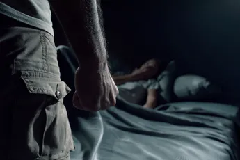Man threatening a woman in the bedroom