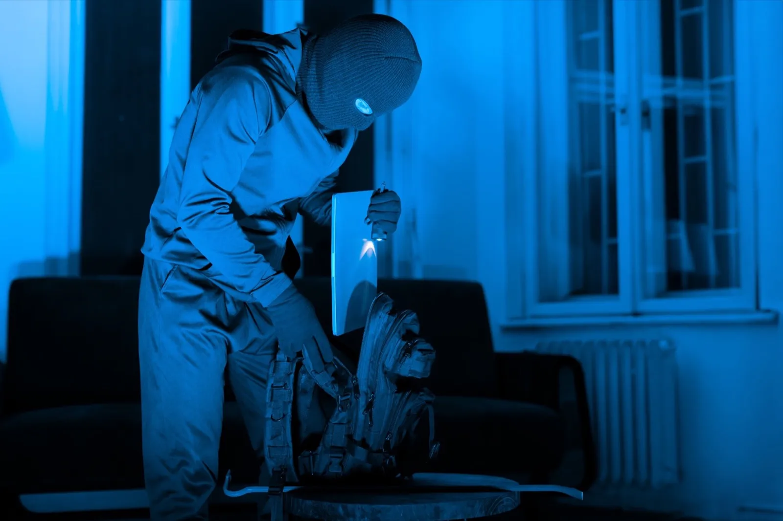 Masked man criminal preparing tools for burglary