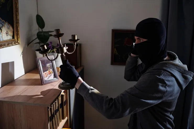 Masked Man Stealing Candlestick during Burglary