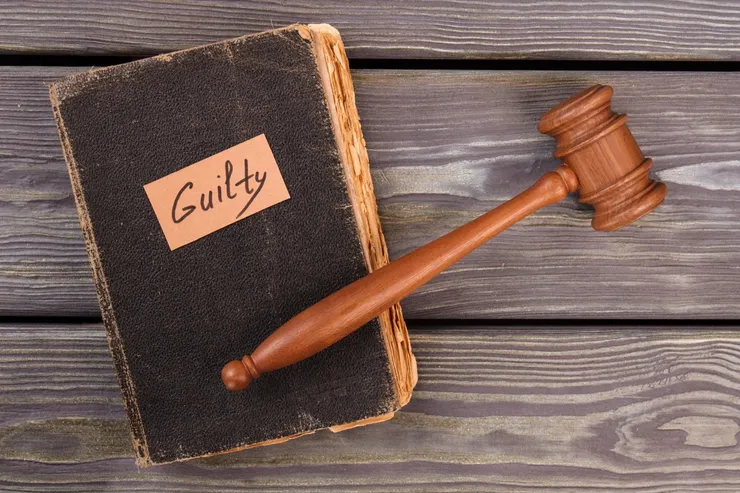 Old book gavel and guilty verdict.