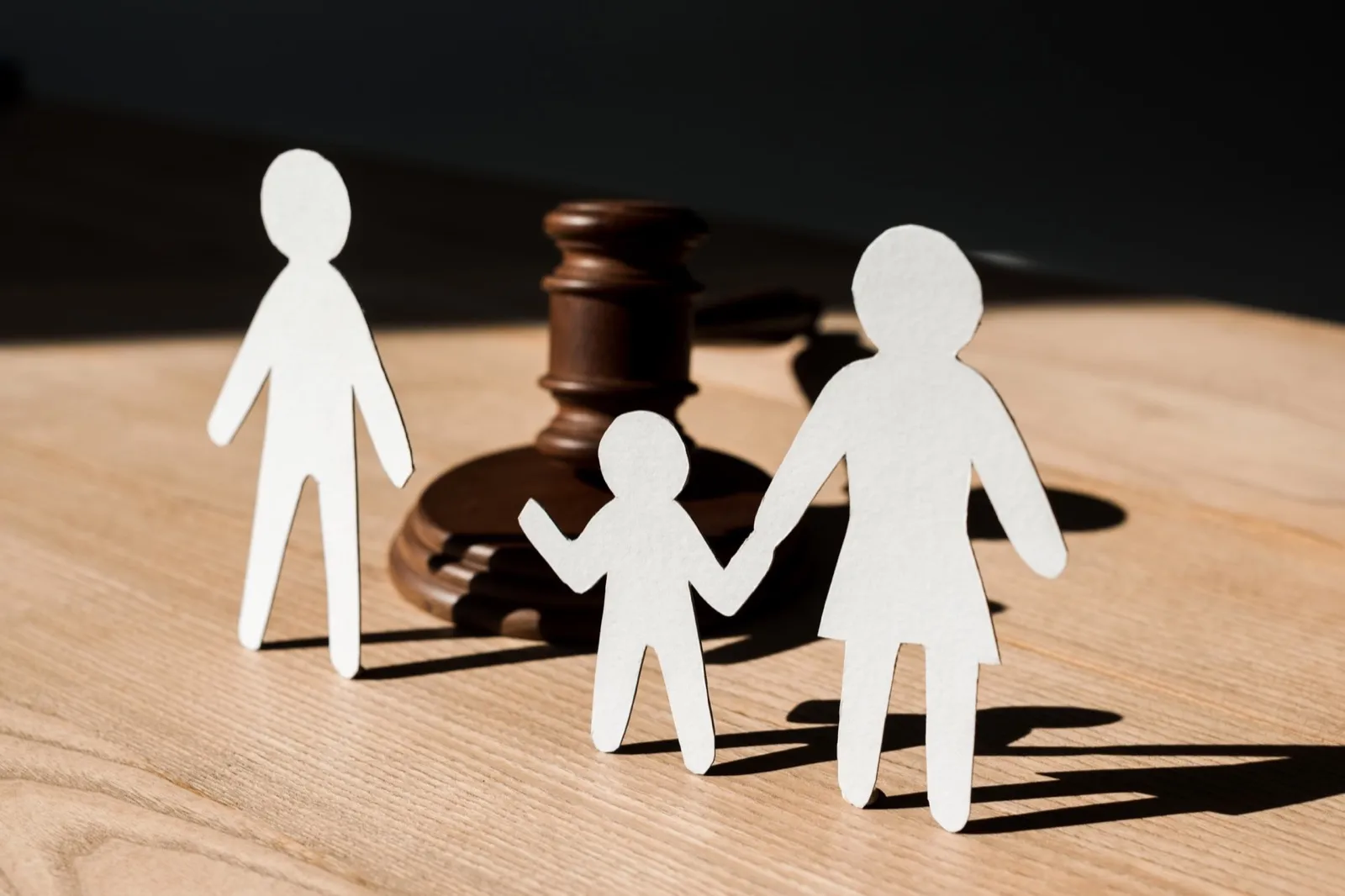 paper people near wooden gavel on table, divorce concept