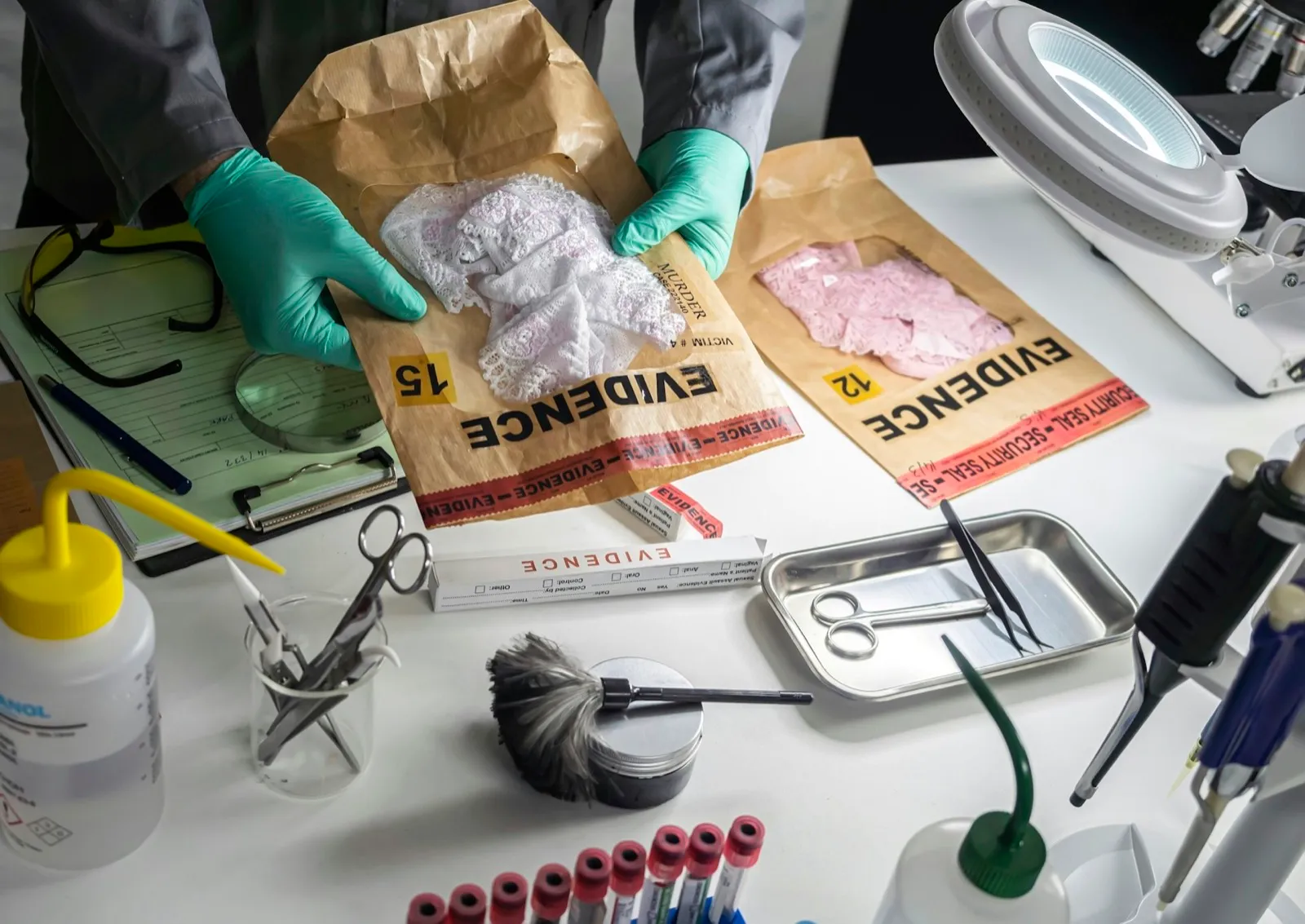 Police scientist holds evidence bag with underwear of sexual assault victim