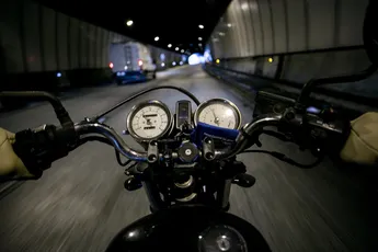 POV motorcycle driver on empty road