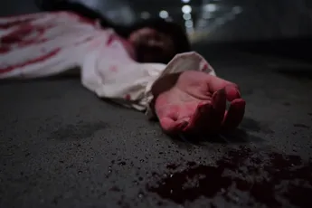 Scary woman in white dress with bloodstain after murder, Halloween concept