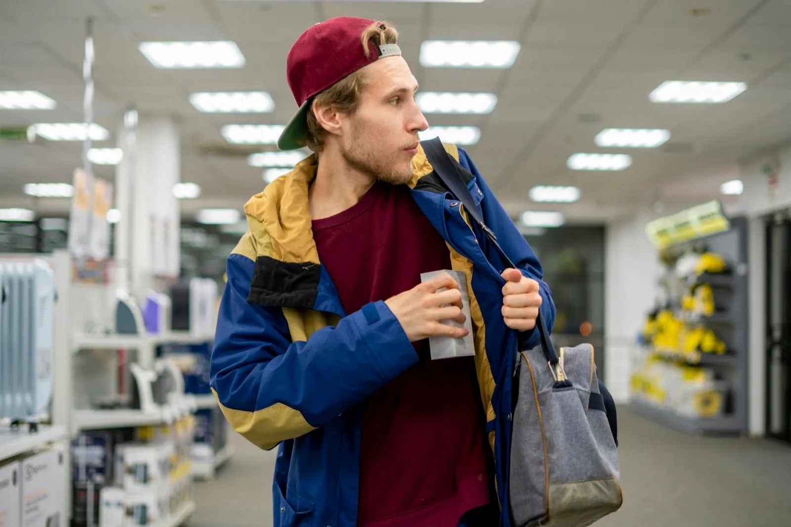 shoplifter in the electronic store supermarket stealing new gadget f