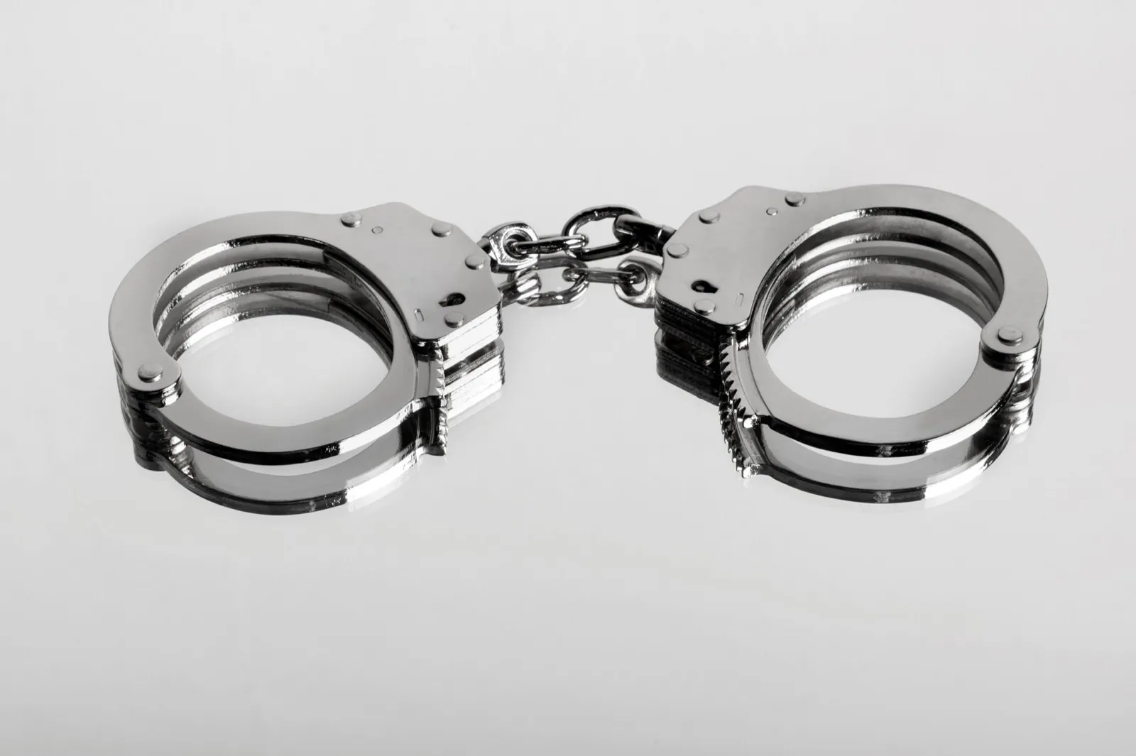 Studio close-up of a locked pair of hiatt type handcuffs