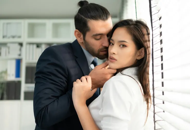 The executive is using his position of power to grope and touch the female employee's body